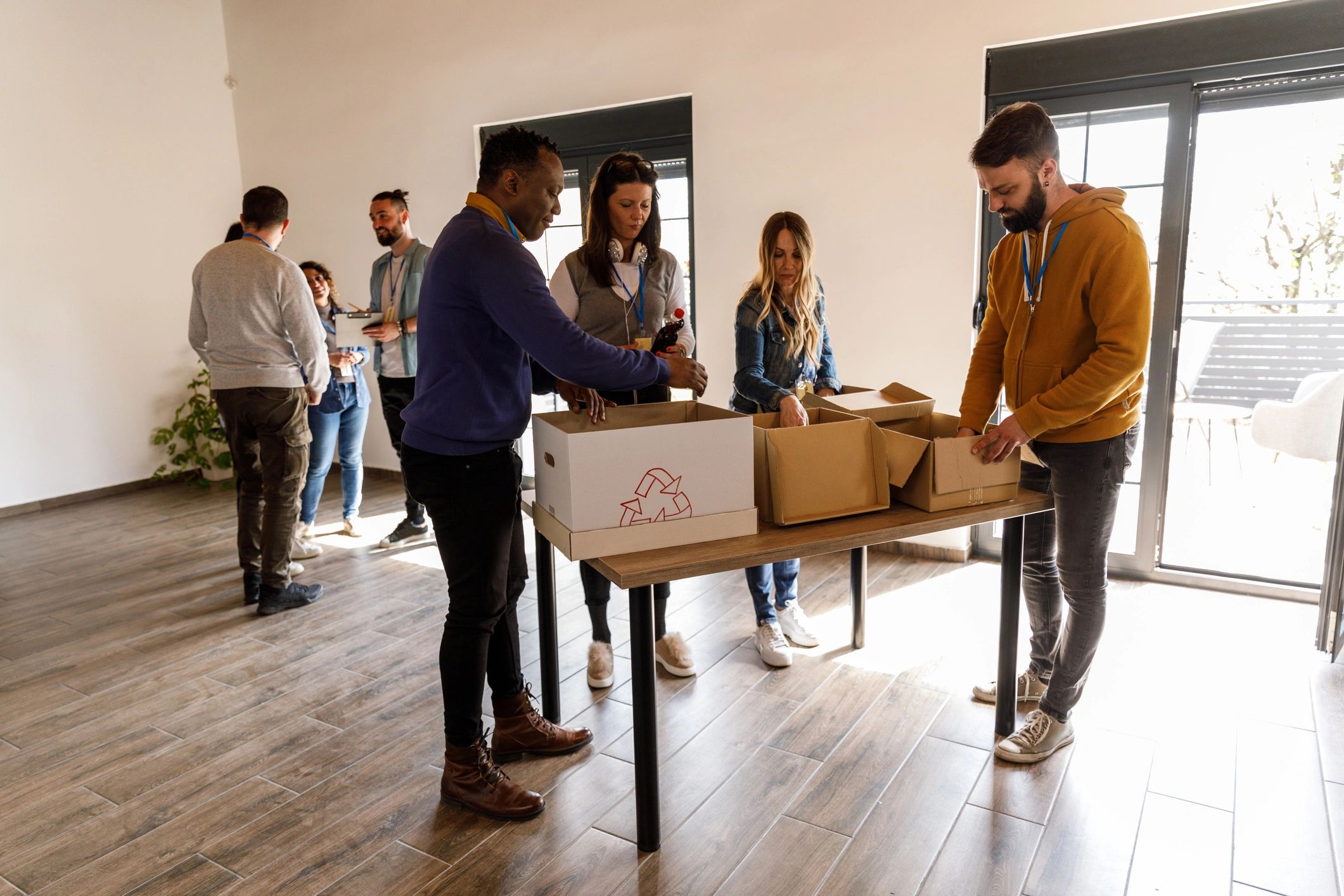 Volunteers sorting donation boxes at a charity center